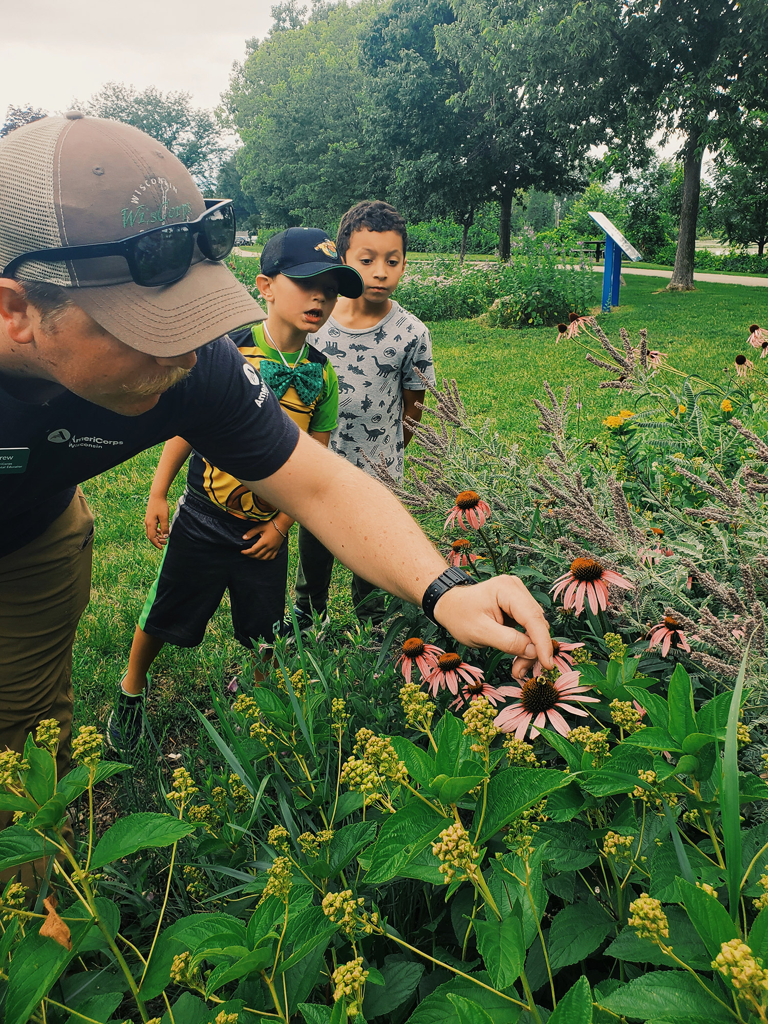 instructor teching kids in gardens