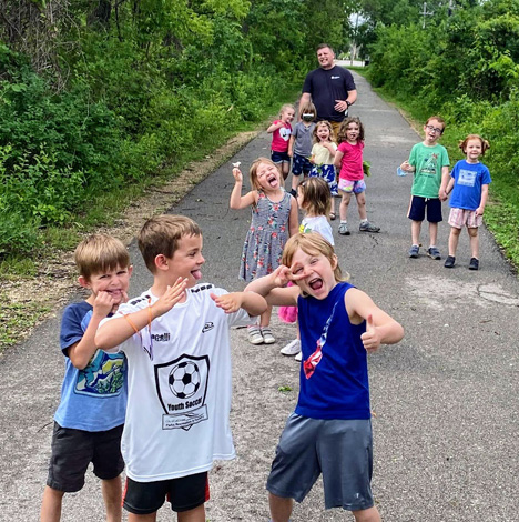 camp kids making funny faces for photo on trail