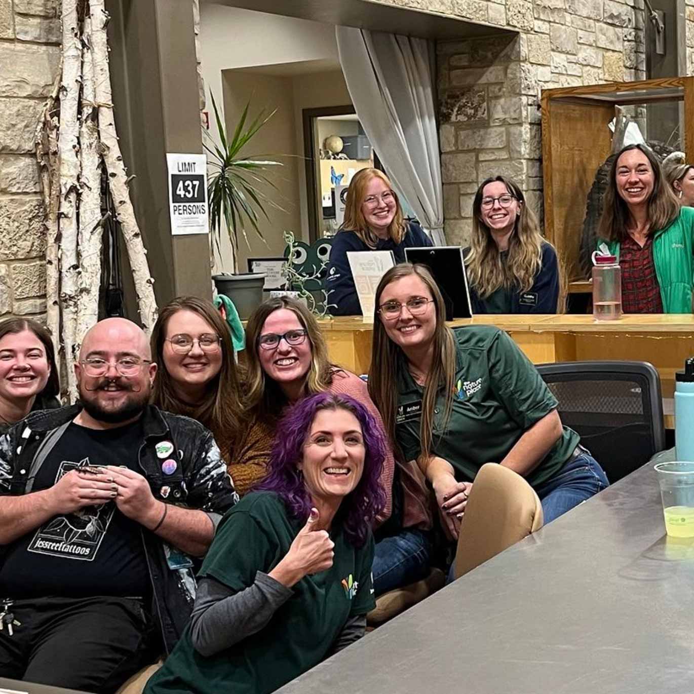 staff posing for pic inside nature center