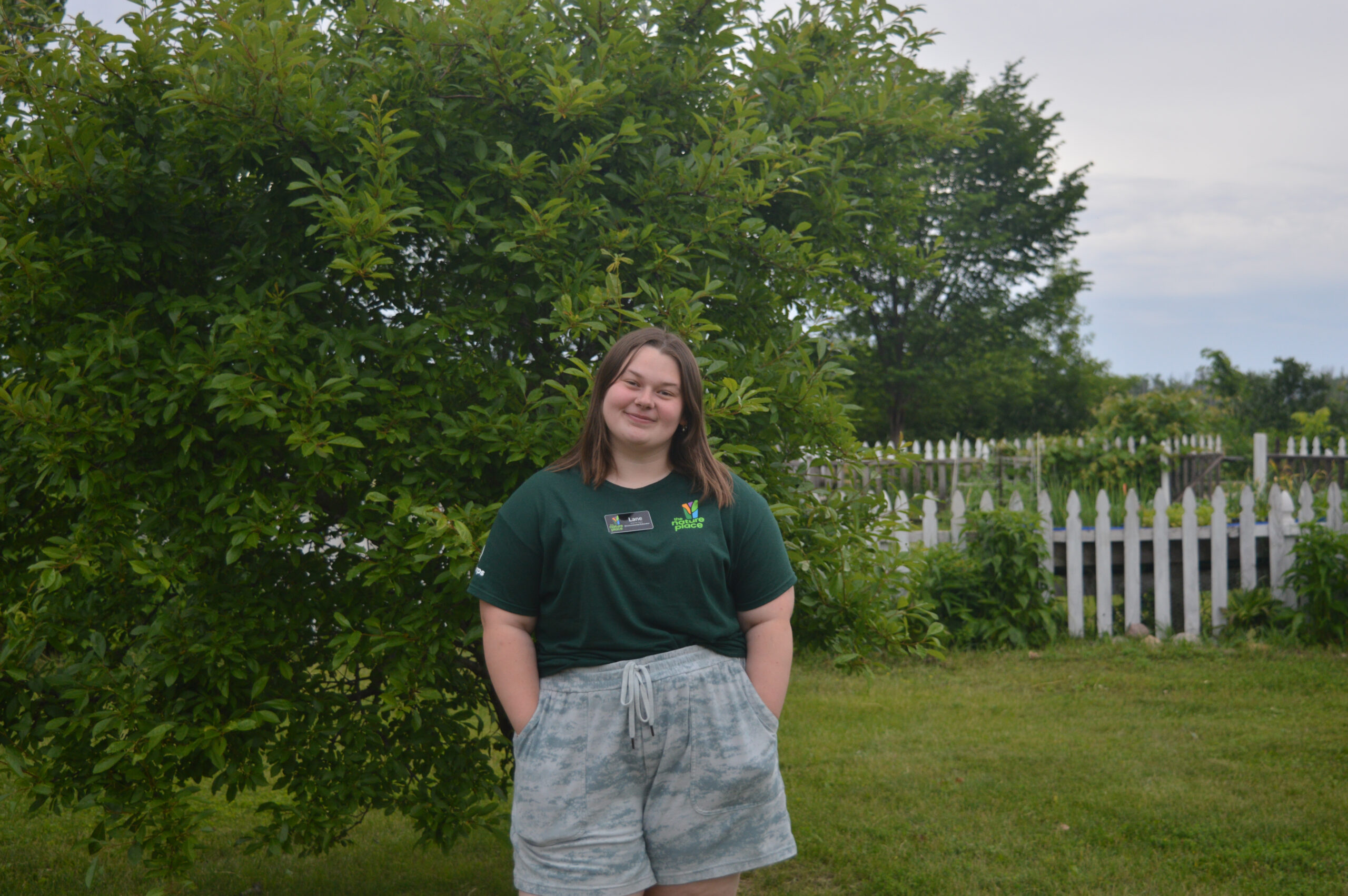 Lane Tracy standing outdoors in front of a tree.