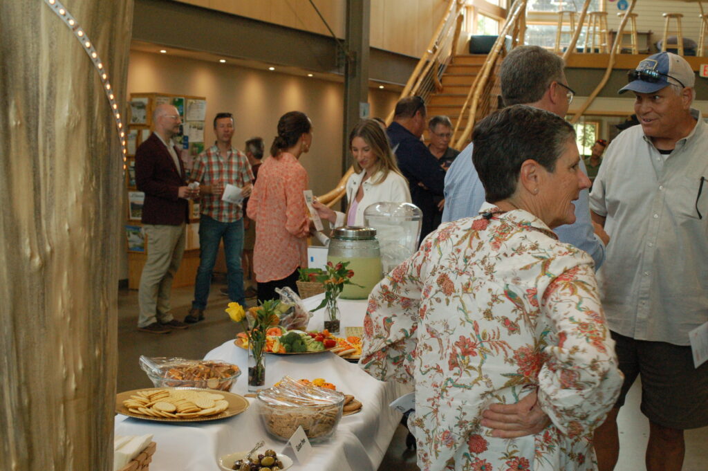 Community enjoying the reception inside The Nature Place following the Ribbon Cutting of the new solar array 