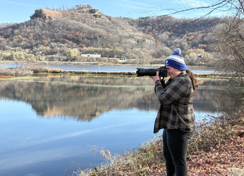 Sophia Sperduto capturing photographs of birds at the La Crosse Marsh.