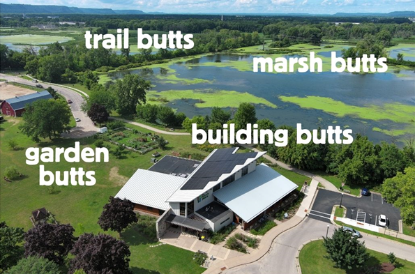 An aerial view of a building with a marsh in the background.