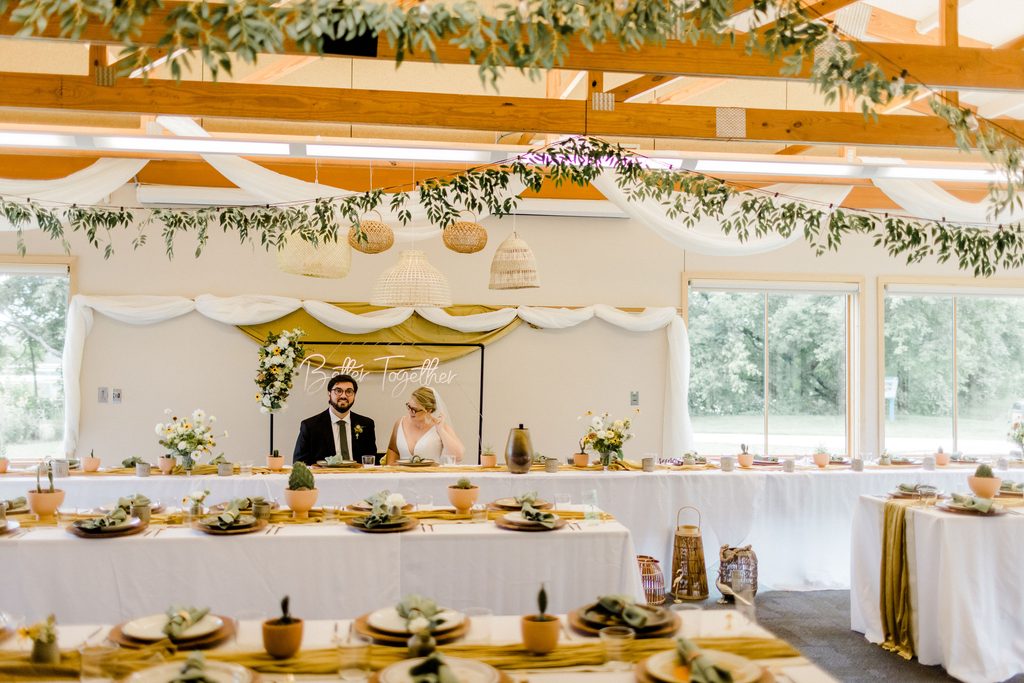 A couple sitting in their wedding space before the festivities begin.