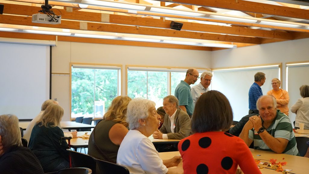 People filling a meeting room before their event begins.